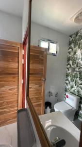 a bathroom with a sink and a toilet and a door at Hin Kong Hide Away 1 in Wok Tum +21 photos