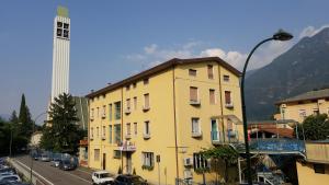 a yellow building on the side of a street at Hotel San Marco BB in Boario Terme