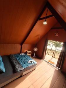 a bed in a room in a attic at Koh Ta Kiev Island Resort in Koh Ta kiev Island