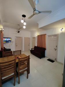 a living room with a table and a couch at Zivo Stays, Heritage Apartments, Rethibowli in Hyderabad