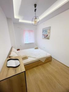 a bedroom with a bed and a table in it at Atila Apartment Ruse in Ruse