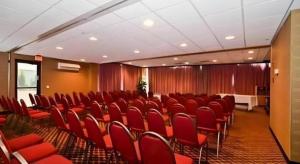 a conference room with red chairs and a table at Travelodge by Wyndham Absecon Atlantic City in Absecon