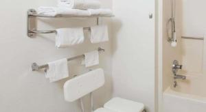 a bathroom with a white toilet and towels at Super 8 By Wyndham Wayne in Wayne +71 photos