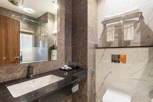 a bathroom with a sink and a mirror at Hotel Sara Sadan in Kathmandu +21 photos