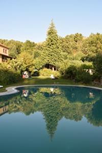 une piscine avec sa réflexion dans l'eau dans l'établissement Quinta Do Crestelo Aparthotel, à Seia