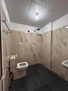 a bathroom with a toilet and a sink at SJ7 Guest House in Mirissa
