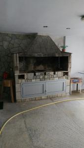 a stone fireplace in a room with a stone wall at Aimilias Family Apartments in Nea Vrasna