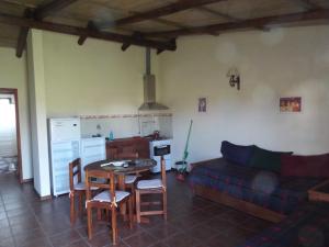 a living room with a table and a couch at El Remanso De Almiron in Termas de Almirón Inmotur