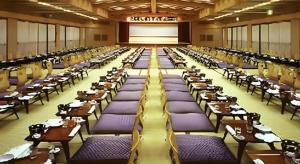 a large room filled with purple tables and chairs at Hotel Shofuen in Toyohashi