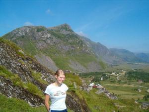 a girl standing on top of a mountain at 7 person holiday home in Bøstad in Alstad