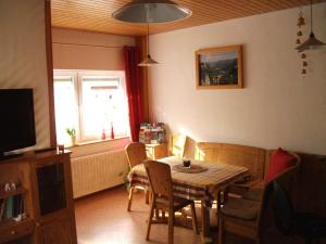 a dining room with a table and chairs and a window at Fewo Benedikta in Beuron