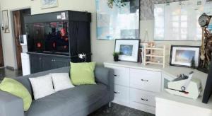 a living room with a gray couch with green pillows at Sherrinton Hotel in Mentekab +58 photos