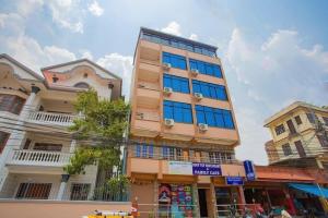 a tall building with blue windows on a city street at Hotel Om in Baudhatinchule