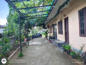 a pergola on the side of a house at Bhasuri AC Room 1 in Agali +4 photos