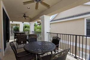 a patio with a table and chairs on a balcony at Orlando Family Friendly Home in Kissimmee