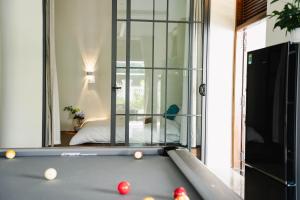 a pool table in a room with a mirror at Villa Doc Let - Your Home in Doc Let in Nha Trang