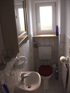 a small bathroom with a toilet and a sink at Fewo Benedikta in Beuron