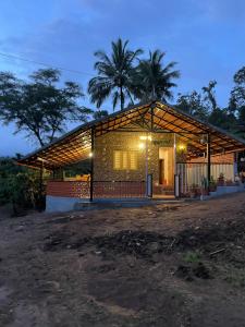 a house is lit up at night at Naad Alaya Estate Stay in Siddapur