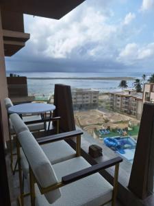 a view of the beach from the balcony of a resort at Almasi Suites at Sandyshore Beach Resort in Kikambala +17 photos
