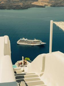 a cruise ship in the water with a cruise ship at Kampanario Luxury Two-Bedroom Villa with Private Jacuzzi in Megalokhori