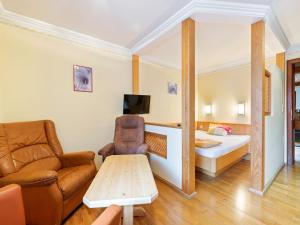 a living room with a couch and a bed at Apartment in Saalbach-Hinterglemm near Ski Area in Saalbach Hinterglemm