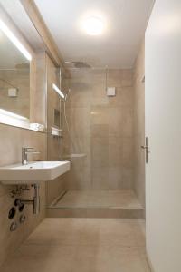 a bathroom with a sink and a shower at Vertical Suite in Zürich