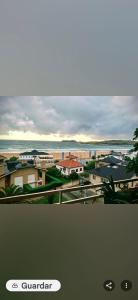 a view of a city with the ocean and buildings at Doña Carmen Playa Boutique in Suances