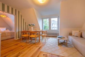 a living room with a table and a couch at Vertical Suite in Zürich