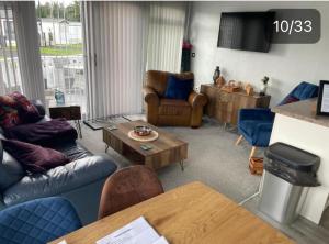 a living room with a couch and a table at Quince on Oakdene country Park in Ringwood