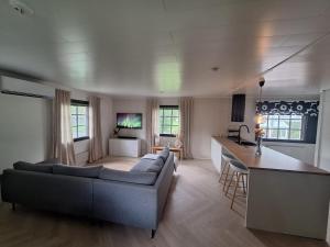 a living room with a couch and a kitchen at Villa Juhala in Rovaniemi