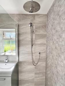a bathroom with a shower and a sink at Camberley Retreat With Paws and Parking in Sandhurst +38 photos