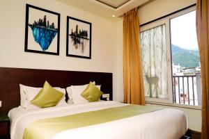 a bedroom with a large bed and a large window at N3N Ganga Retreat by Stotrak in Rishīkesh +80 photos