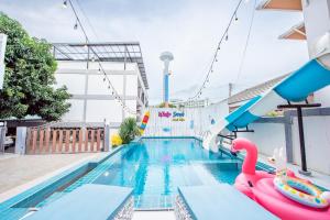 a pool with a water slide and a pool noodle at White Sand Pool Villa Pattaya in Jomtien Beach
