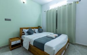 Ένα ή περισσότερα κρεβάτια σε δωμάτιο στο Coorg Tranquil Retreat