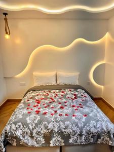 a bedroom with a bed with red flowers on it at Soho Heaven - Cloud & Relaxation Atmosphere 2 Bedrooms in Essaouira +18 photos