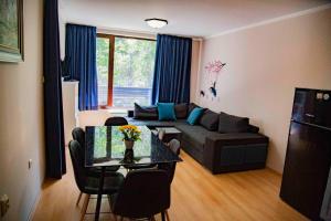a living room with a couch and a table at Forest Dream Apartment - Elit Pamporovo in Pamporovo