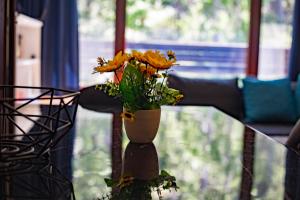 a vase with flowers sitting on a table at Forest Dream Apartment - Elit Pamporovo in Pamporovo