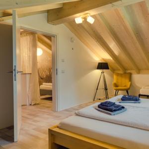 a bedroom with a bed and a yellow chair at Wäller Haus - Modern villa with fireplace & large natural garden in Breitscheid