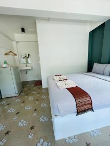 a bedroom with two beds with towels on the bed at Smile Resort Koh Mook in Koh Mook +183 photos