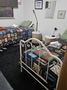 a room with two beds in a room at The Shed in Cooma