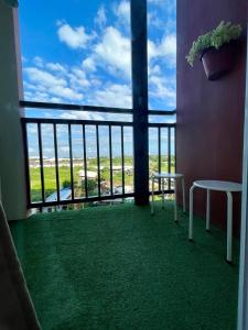 a room with a balcony with a view of the ocean at Modern Retreat with Private Balcony in Mactan Island