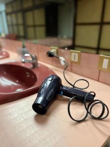 a pair of scissors sitting on a counter next to a sink at Papeete Secret Spot in Papeete