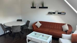 a living room with a couch and a table at Gemütliche Wohnung, Heimkino, Couch & Küche in Siegen +10 photos