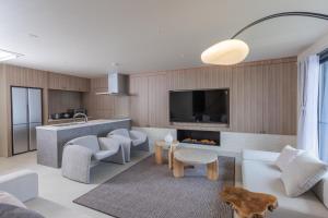 a living room with a couch and a fireplace at Vast Bleu IWAYA in Awaji