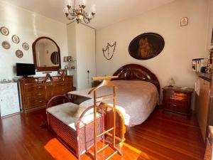 a bedroom with a bed and a dresser and a mirror at Le Pergole in Trieste +15 photos