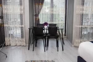 a dining room table with four chairs in front of a window at Sultan Han Luxery Hotel in Istanbul