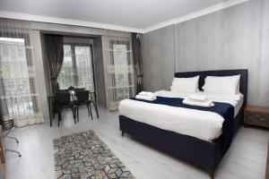 a bedroom with a large bed with two towels on it at Sultan Han Luxery Hotel in Istanbul