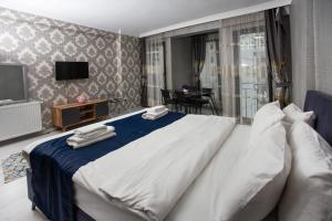 a bedroom with a large bed with towels on it at Sultan Han Luxery Hotel in Istanbul