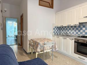 a kitchen with a table and a table and chairs at Casa Amatucci in Santa Maria di Castellabate +4 photos