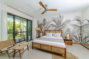a bedroom with a bed and a ceiling fan at La Residence Sea Horse and Seashell Beachfront Apartment 23 in Cap Malheureux
